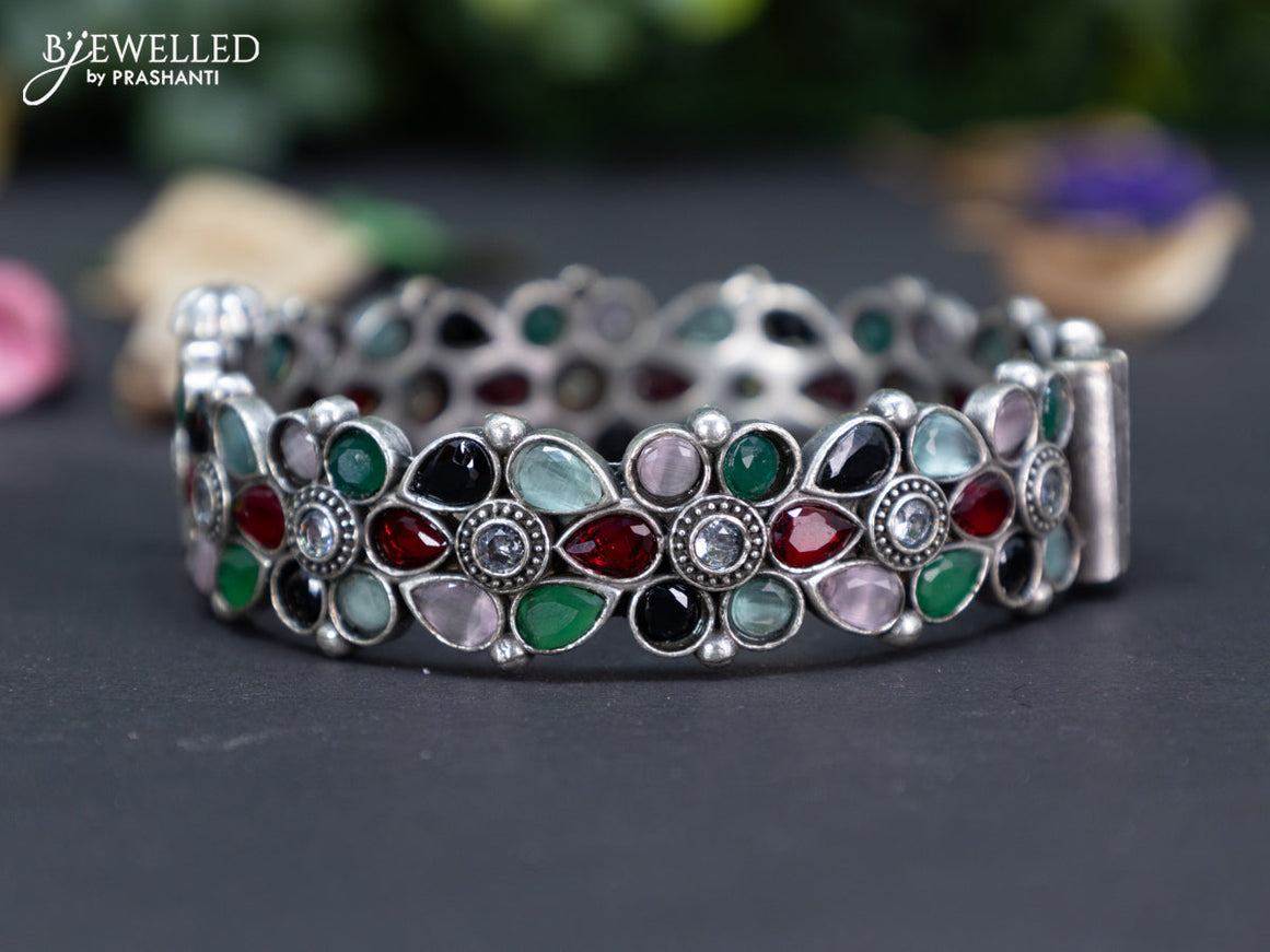 Oxidised floral design screw type bangle with multi colour stones