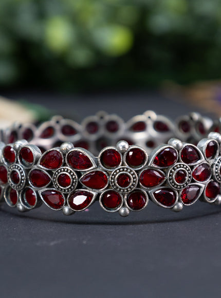 Oxidised floral design screw type bangle with maroon stones