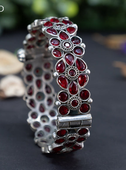 Oxidised floral design screw type bangle with maroon stones