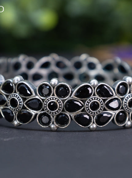 Oxidised floral design screw type bangle with black stones