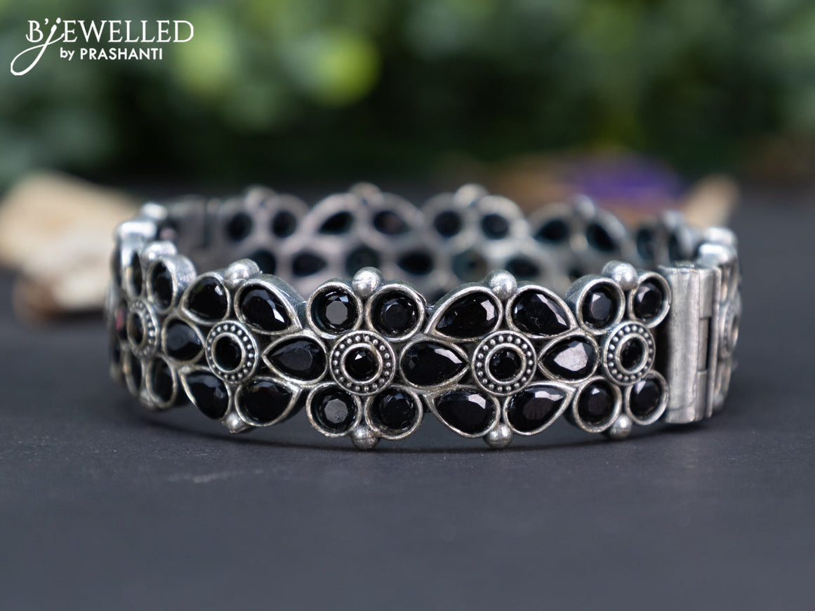 Oxidised floral design screw type bangle with black stones