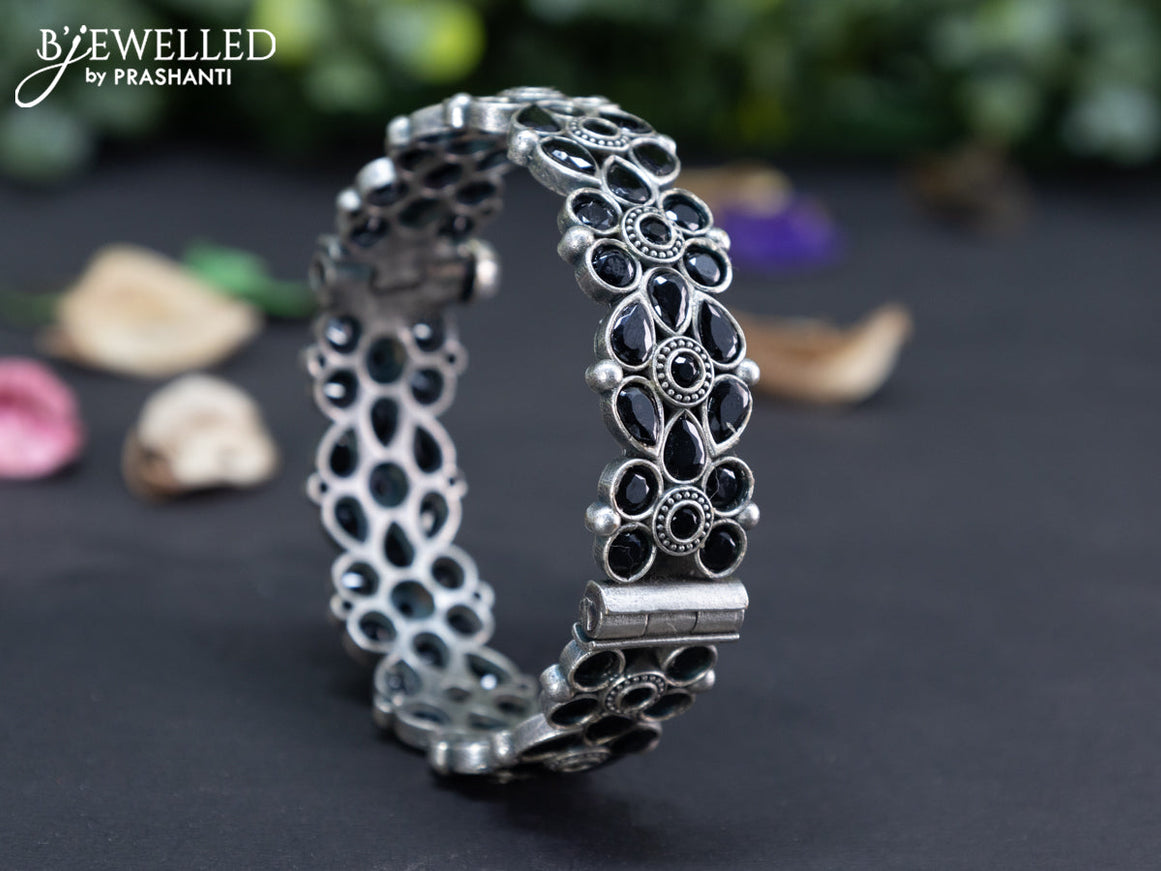 Oxidised floral design screw type bangle with black stones