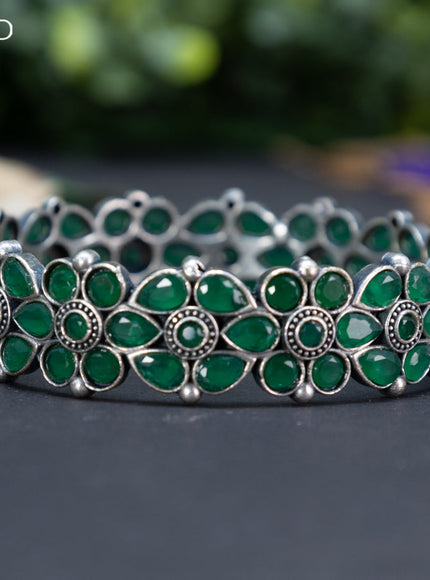 Oxidised floral design screw type bangle with emerald stones