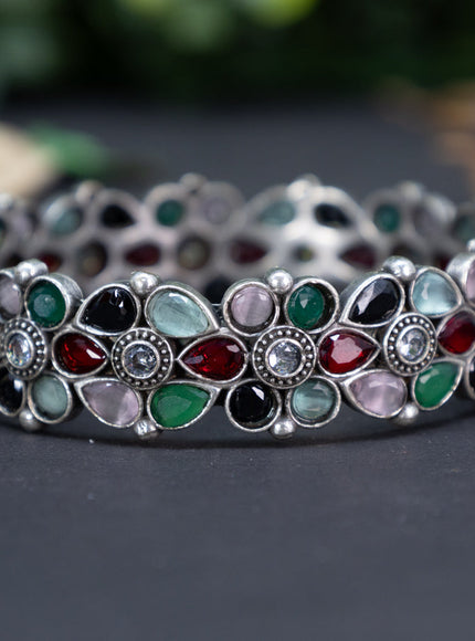 Oxidised floral design screw type bangle with multi colour stones