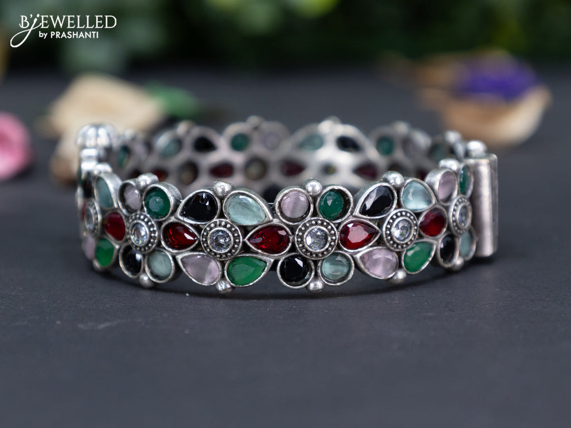 Oxidised floral design screw type bangle with multi colour stones