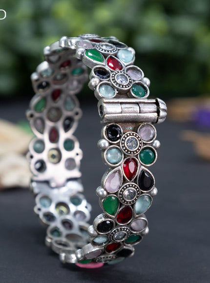 Oxidised floral design screw type bangle with multi colour stones