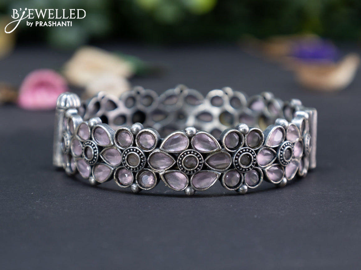 Oxidised floral design screw type bangle with baby pink stones