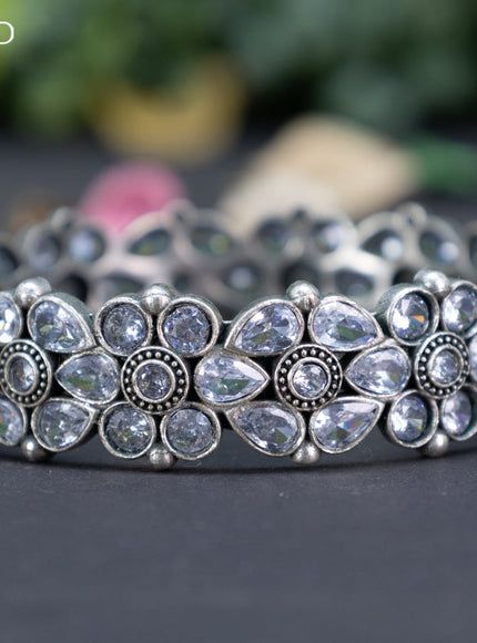 Oxidised floral design screw type bangle with cz stones