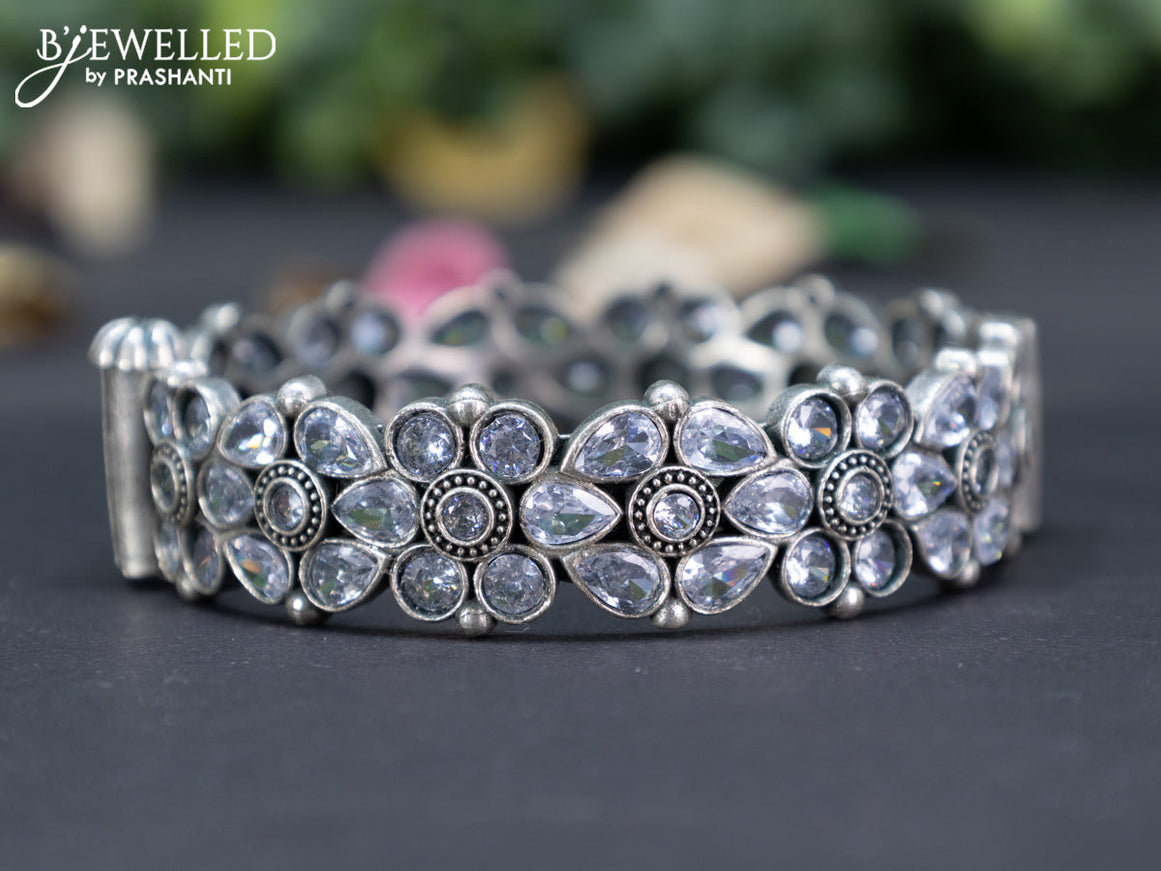 Oxidised floral design screw type bangle with cz stones