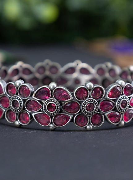 Oxidised floral design screw type bangle with ruby stones