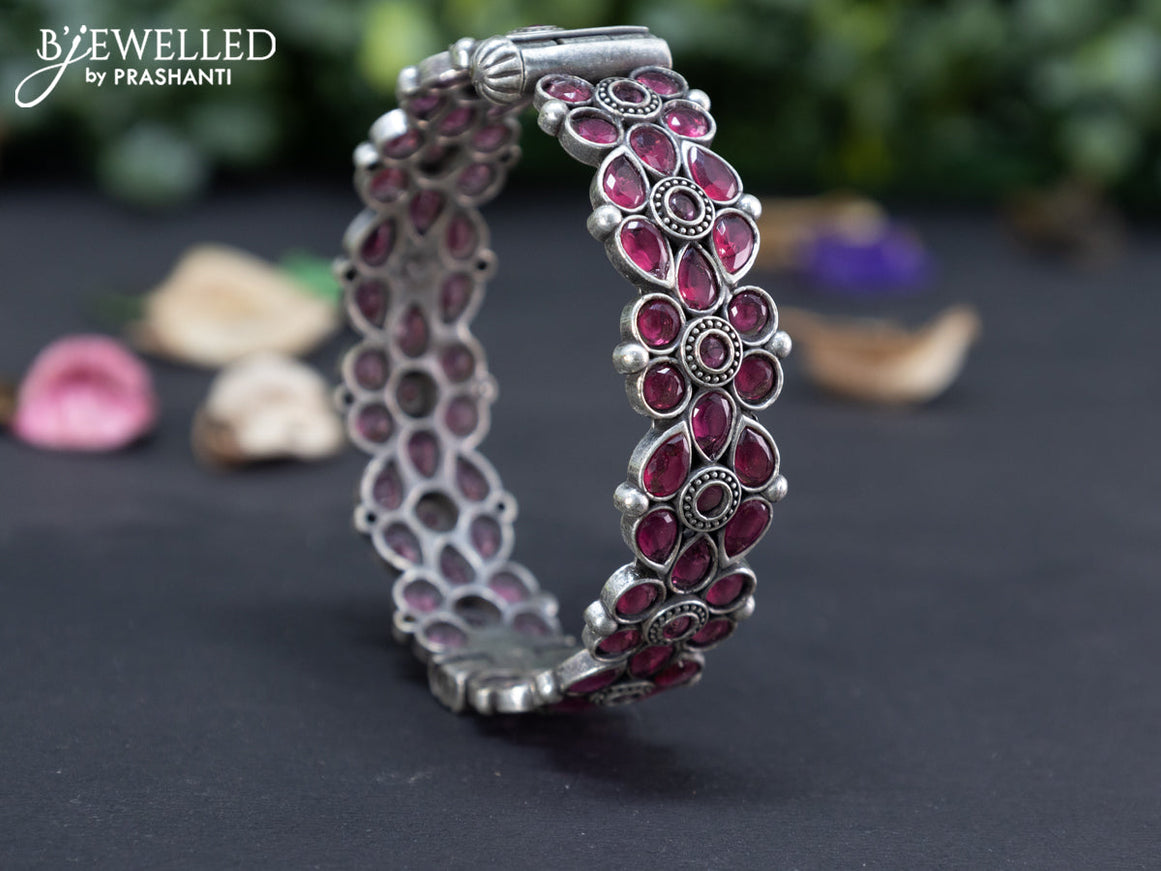 Oxidised floral design screw type bangle with ruby stones