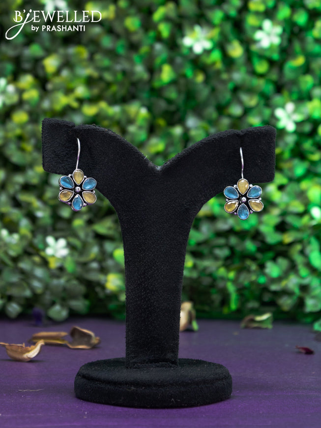 Oxidised hanging type earring with yellow and ice blue stones