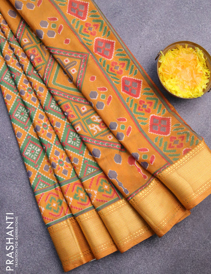 Semi tussar saree mustard yellow and green with allover ikat prints and zari woven border