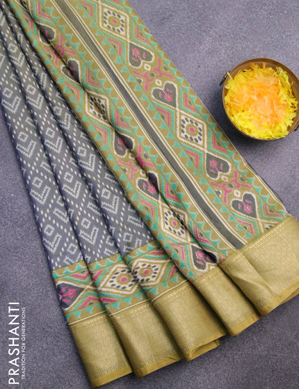 Semi tussar saree dual shade of greyish green and elaichi green with allover ikat prints and zari woven border