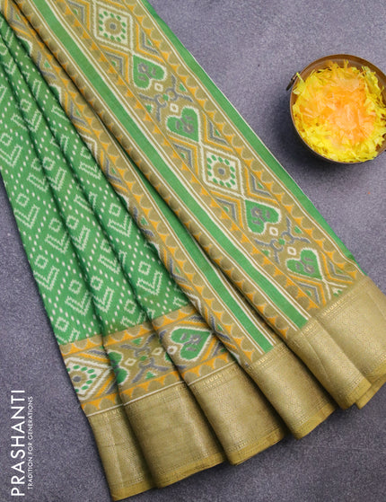 Semi tussar saree green shade with allover ikat prints and zari woven border