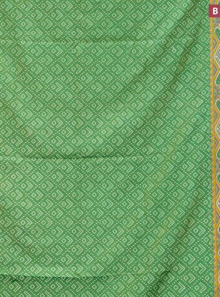 Semi tussar saree green shade with allover ikat prints and zari woven border