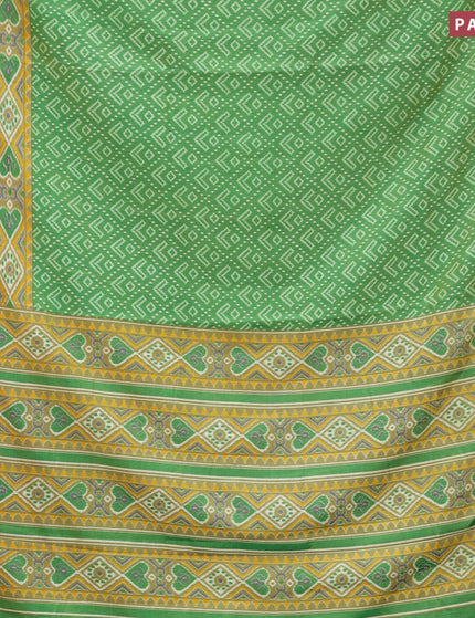 Semi tussar saree green shade with allover ikat prints and zari woven border