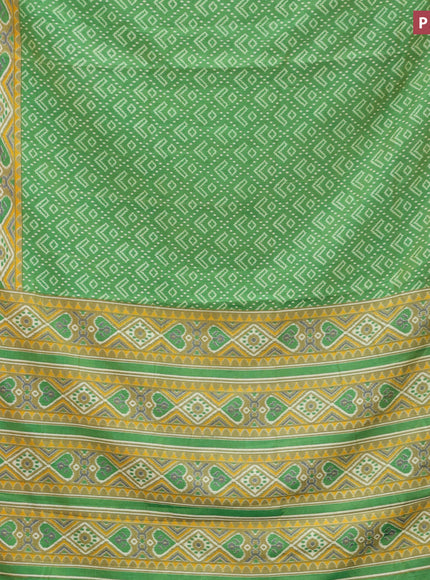 Semi tussar saree green shade with allover ikat prints and zari woven border