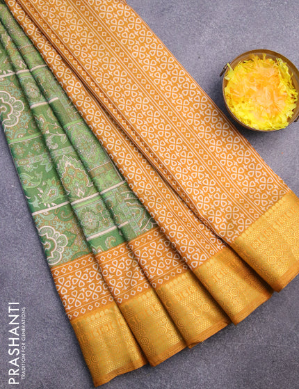 Semi tussar saree green shade and mustard shade with allover ikat prints and zari woven border