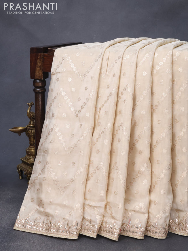 Banarasi silk saree cream with allover zari weaves and zari woven gottapatti lace work border