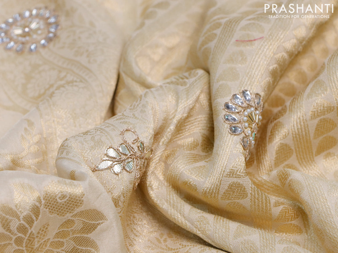 Banarasi silk saree cream with allover zari woven banarasi weaves and zari woven gottapatti lace work border