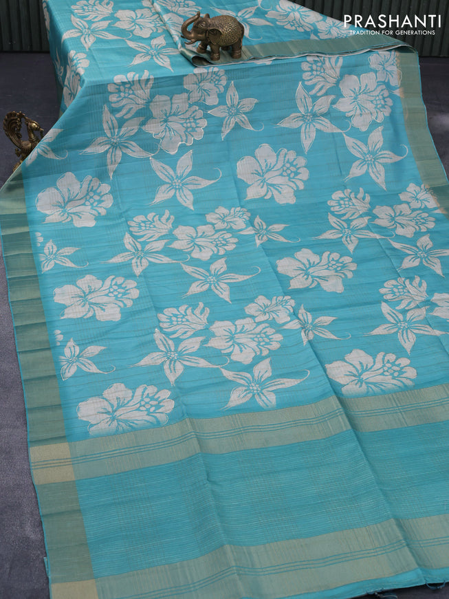 Semi matka foil printed saree teal blue with allover floral prints & zari weaves and zari woven border