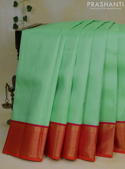 Pure kanjivaram silk saree teal green shade and dual shade of pinkish orange with plain body and zari woven korvai border