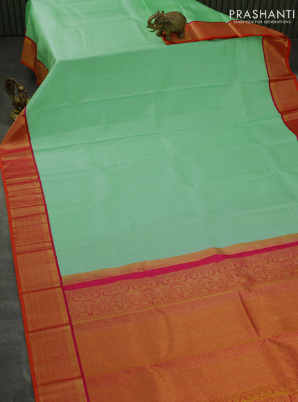 Pure kanjivaram silk saree teal green shade and dual shade of pinkish orange with plain body and zari woven korvai border