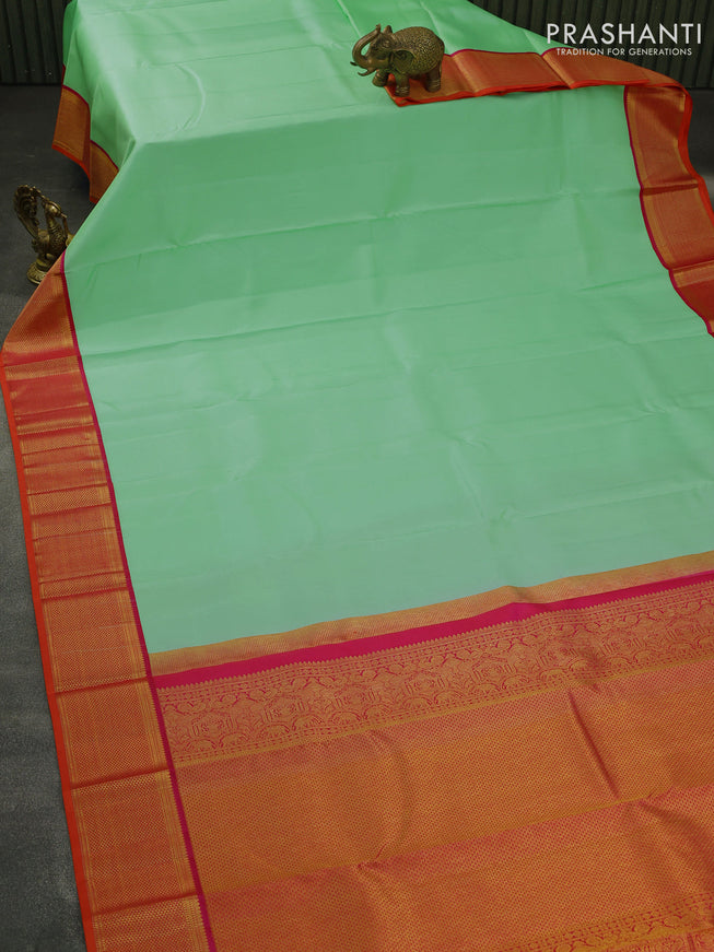 Pure kanjivaram silk saree teal green shade and dual shade of pinkish orange with plain body and zari woven korvai border