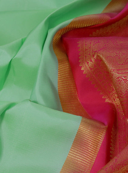 Pure kanjivaram silk saree teal green shade and dual shade of pinkish orange with plain body and zari woven korvai border