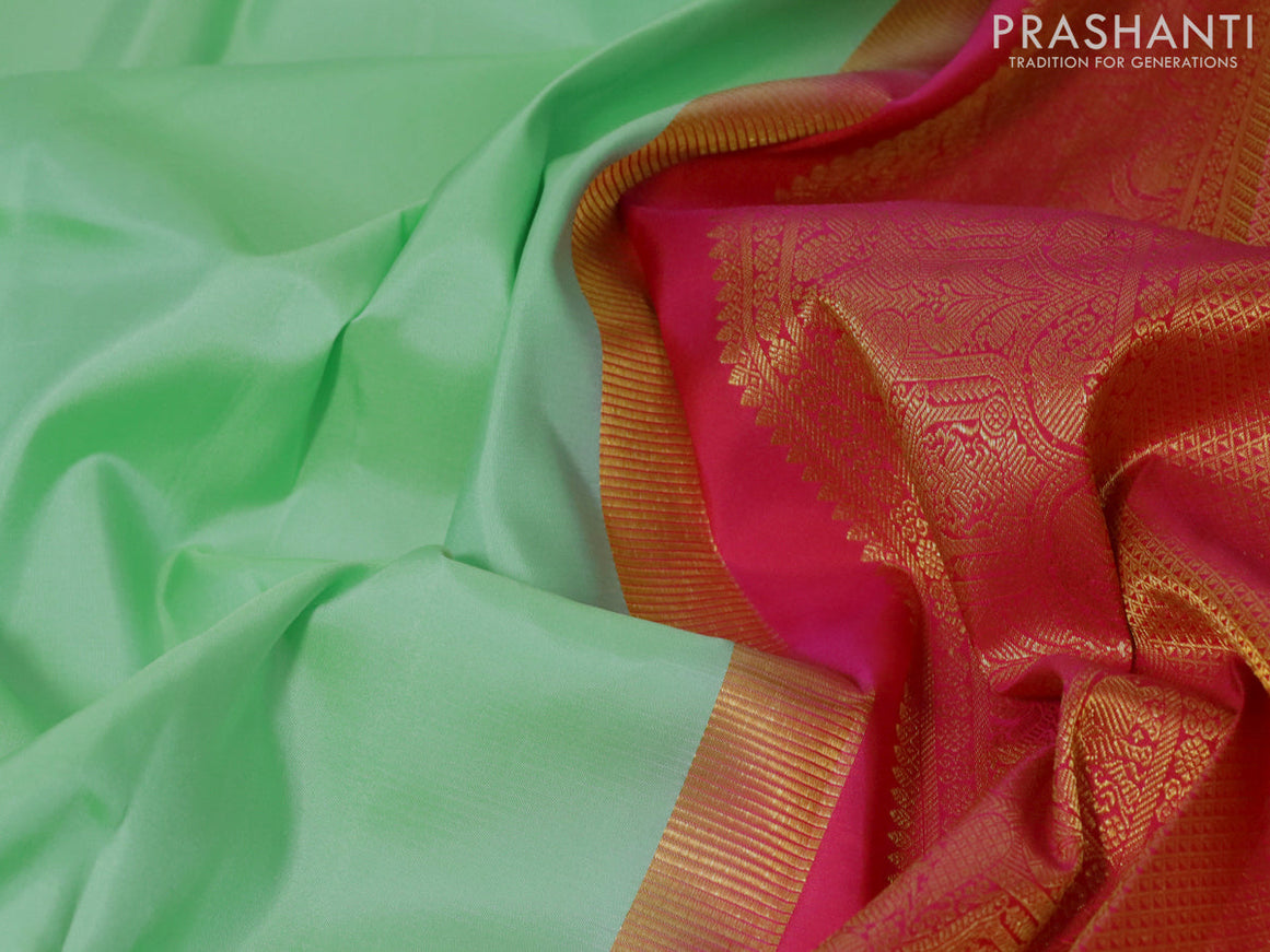 Pure kanjivaram silk saree teal green shade and dual shade of pinkish orange with plain body and zari woven korvai border