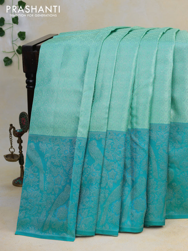 Pure kanjivaram tissue silk saree teal blue and cs blue with allover silver zari weaves and long silver zari woven border