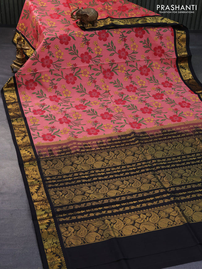 Silk cotton saree peach pink and black with allover floral prints and zari woven korvai border