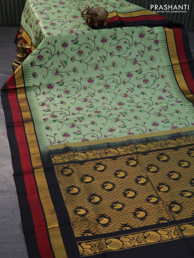 Silk cotton saree pastel green and black with allover pichwai prints and temple design zari woven simple border