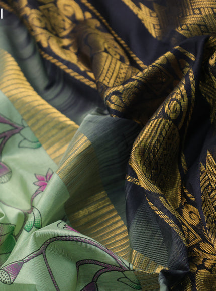 Silk cotton saree pastel green and black with allover pichwai prints and temple design zari woven simple border