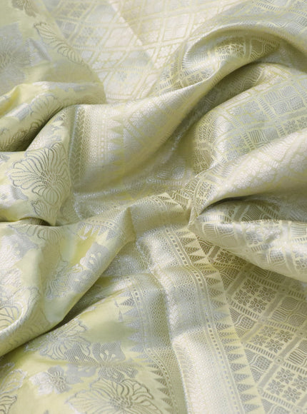 Chiniya silk saree pale yellow with allover silver zari weaves and floral design zari border