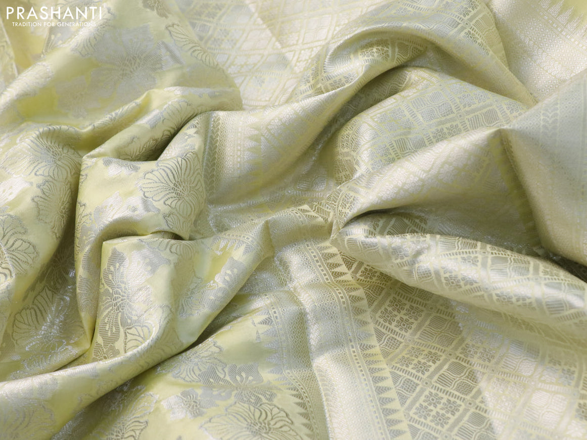 Chiniya silk saree pale yellow with allover silver zari weaves and floral design zari border