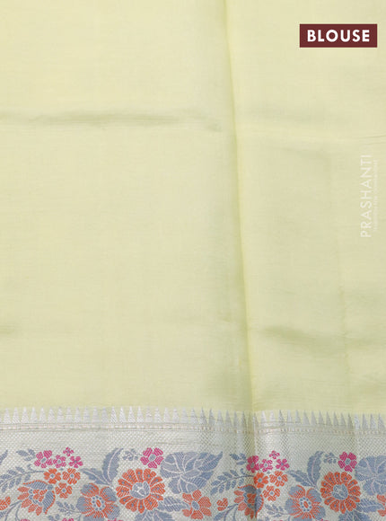 Chiniya silk saree pale yellow with allover silver zari weaves and floral design zari border