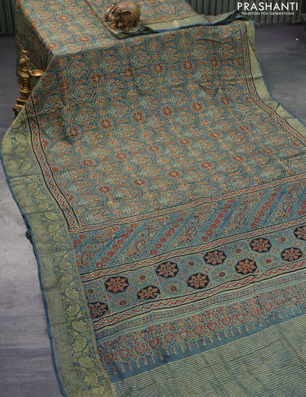 Dola silk saree blue shade with allover ajrakh prints and zari woven border