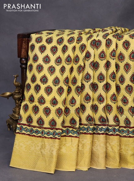 Dola silk saree yellow with allover ajrakh prints and zari woven border