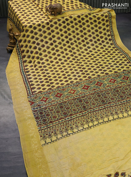 Dola silk saree yellow with allover ajrakh prints and zari woven border