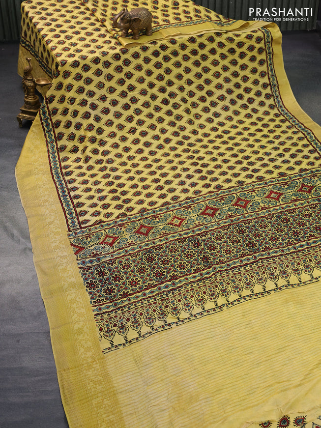 Dola silk saree yellow with allover ajrakh prints and zari woven border