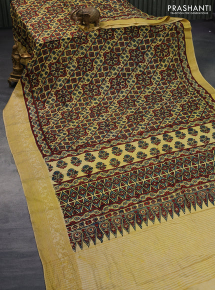 Dola silk saree yellow with allover ajrakh prints and zari woven border