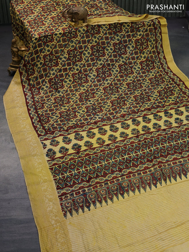 Dola silk saree yellow with allover ajrakh prints and zari woven border