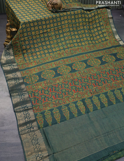 Dola silk saree green with allover ajrakh prints and zari woven border