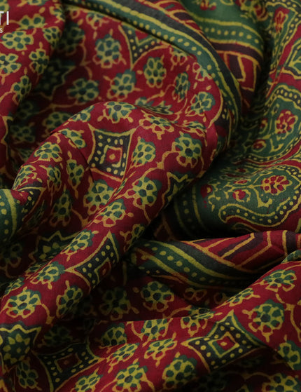 Dola silk saree green and red with allover ajrakh prints and zari woven border