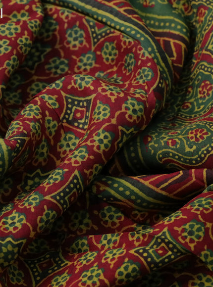 Dola silk saree green and red with allover ajrakh prints and zari woven border