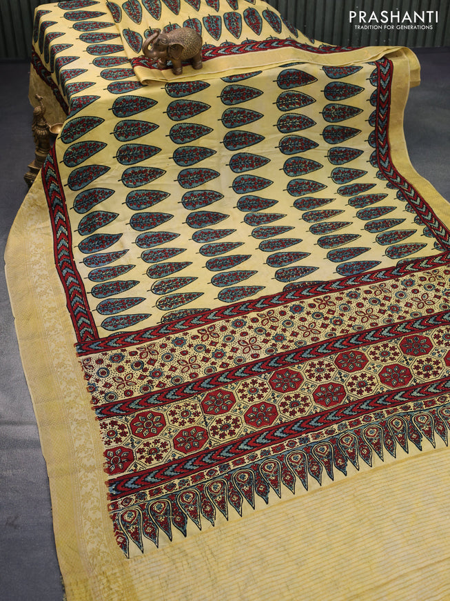 Dola silk saree pale yellow with allover ajrakh prints and zari woven border