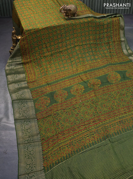 Dola silk saree green and red with allover ajrakh prints and zari woven border