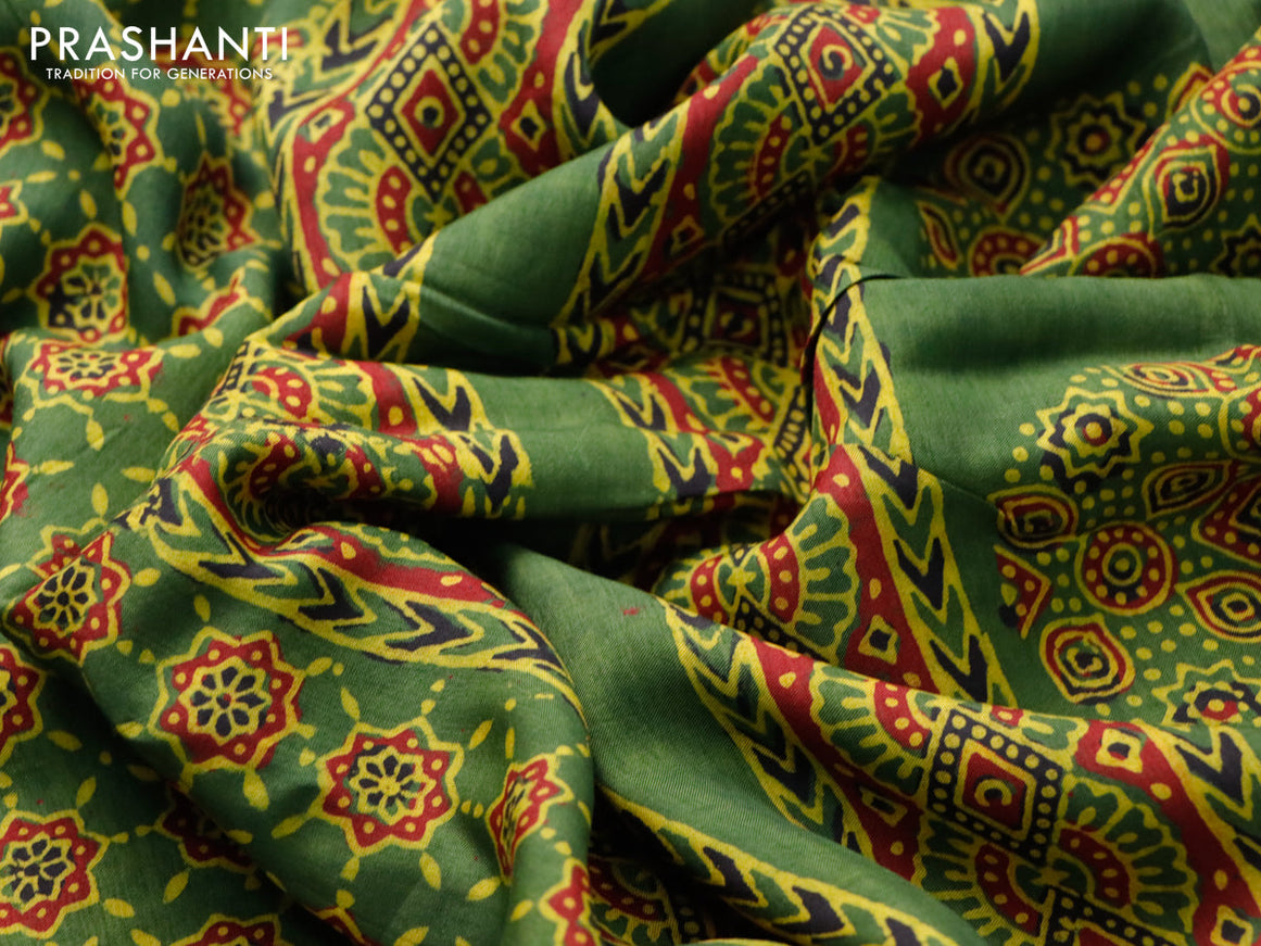 Dola silk saree green and red with allover ajrakh prints and zari woven border